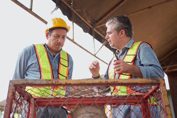 Team of workers at construction site with heavy machines.