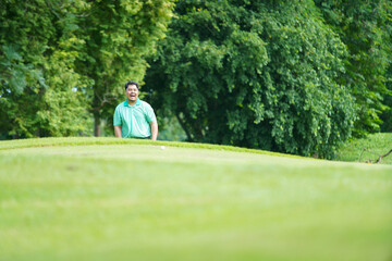 Man is playing golf in morning.