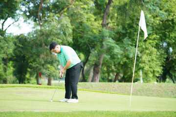 Obraz premium Man is playing golf in morning.