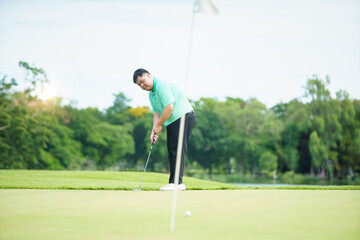 Man is playing golf in morning.