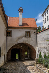 Inside Ptuj castle in Slovenia, restored gate building, church tower, cobblestone pavement