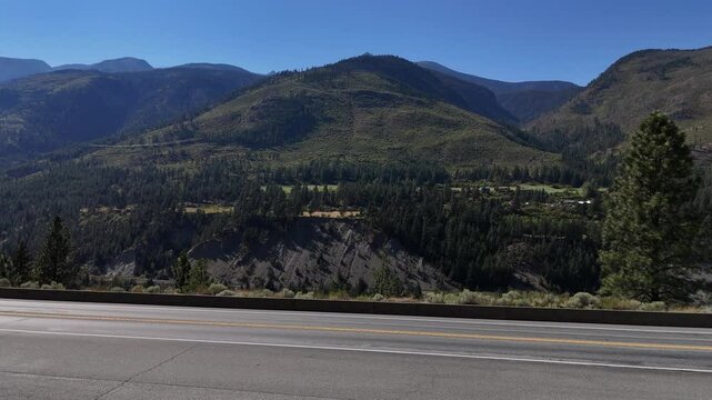 Aerial view (boom up / pan right) of Fraser Canyon during a summer season in British Columbia, Canada