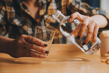 healthy beautiful young woman holding glass of water