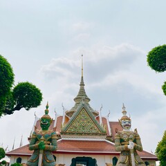 Fototapeta premium Two Titans in front of the arch at Wat Suthat in Bangkok, Thailand