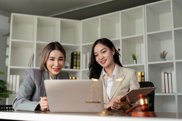 Two Asian female lawyers collaborating on legal solutions