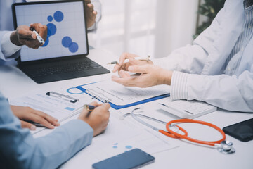 Meeting, tablet and team of doctors with collaboration for healthcare talk and telehealth app in office. Surgeon group, tech and medical discussion with website for hospital funding or sponsorship