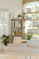 A space for displaying products on a wooden table in a minimalist room.
