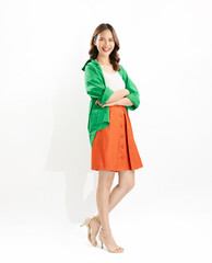 Young Asian woman exudes happiness, displaying a joyful expression as she stands against a white background.