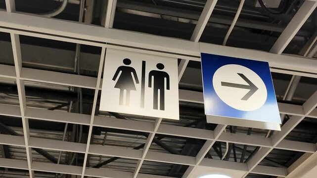 A lady and a man toilet sign on top
