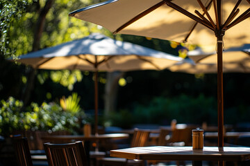 Cafe umbrellas, tables, and chairs bathed in sunlight