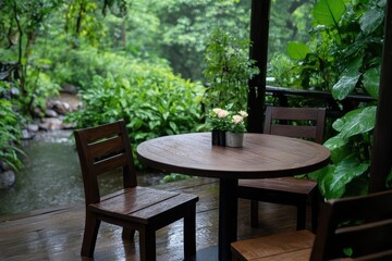 Obraz premium A serene outdoor setting featuring a wooden table and chairs surrounded by lush greenery and a gentle water stream.