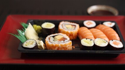 Sushi on vibrant red plate, showcasing health benefits of fresh, eco-friendly seafood. Enjoy meal that is not only delicious but also good for planet, embracing best of sustainable dining.