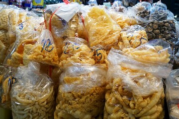 A pile of pork crackling in a plastic package for sale in the market.
