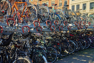 Many bicycles parked at a public bike rack in Copenhagen. Bike parking in Copenhagen. Concept of...