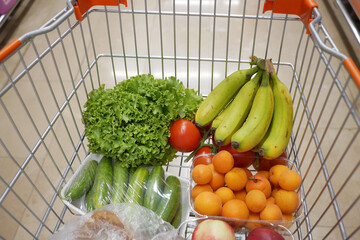 Shopping cart full of groceries .