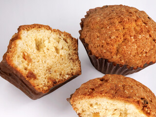 Whole and half muffin on a white background.