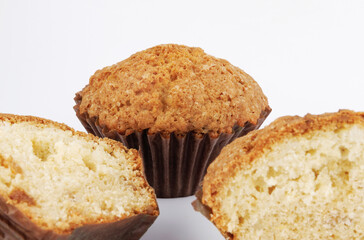 Whole and half muffin on a white background.