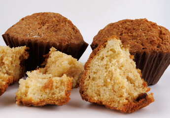 Muffin and muffin pieces on a white background.
