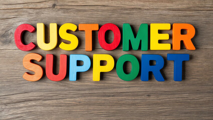 Fototapeta premium customer support word colorful wooden letters on plain white background