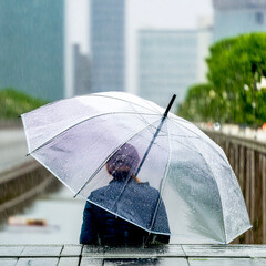 Rainy day and a person puts up an umbrella.