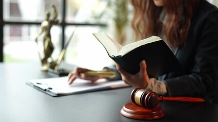 Female lawyer in office Business woman sitting and reading contract documents law book legal services Validation of documents, business contracts, advice, fairness, real estate concepts.