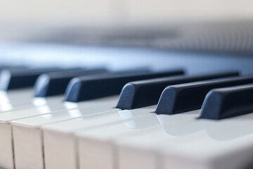 Close up shot of Piano key with Bokeh effects in background. Music background and texture with Bokeh effect.