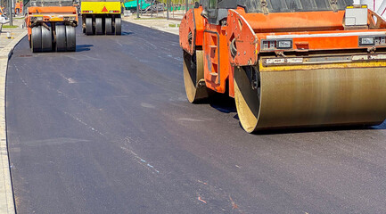 A roller rolls asphalt on a new road