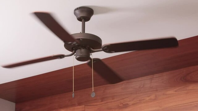 Anonymous turn on wooden ceiling fan. Modern device for cooling room with variable speed control. Summer and heat.