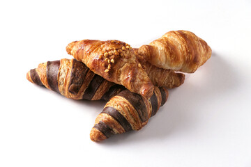 Freshly baked golden croissants in various flavors arranged on a white background.