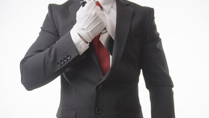 Headless businessman in suit wearing white gloves pull out a secret knife