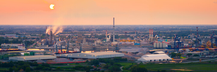 Industrial and port area of Ravenna ,chemical and petrochemical pole,thermoelectric,metallurgical plants and hydrocarbon refinery and liquefied natural gas tanks at sunset