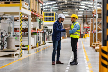 Supervisor, manager scolding employee in modern industry factory. Worker making mistake. Production...