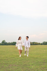 Happy young Asian couple in bride and groom clothing