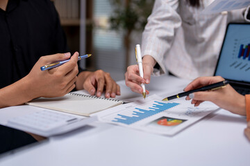 Business people analyzing financial documents with charts and graphs
