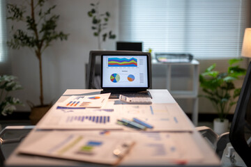 Financial data displayed on tablet in an office with no people present