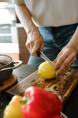 Unrecognizable woman cutting a lemon in half