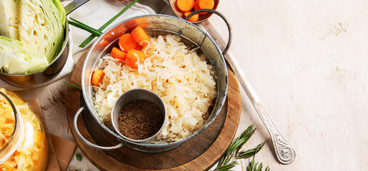 Winter salad of marinated cabbage and carrot Homemade sauerkraut in a jar on wooden background