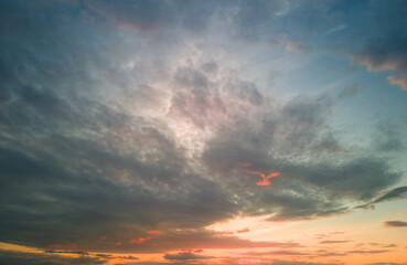 The rays of the sun breaking through the dramatic clouds in the evening or in the morning in the sunset or sunrise sky.