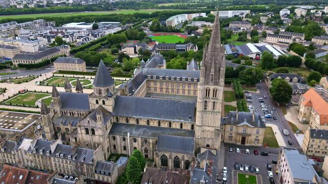 Tracking aerial movement about the L'Abbaye-aux-Hommes abbey with St. Etienne church in the background, Caen, France.