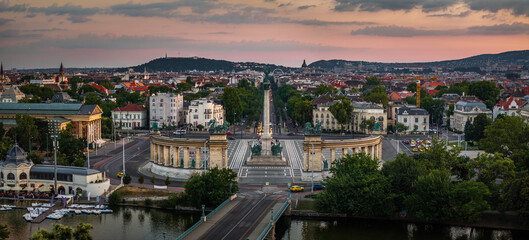 Budapest, Hungary - Aerial panoramic view of Heroes' Square by City Park at sunset with colorful dramatic sky and Andrassy street at background