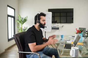 young indian man call center agent  wearing headset talking to client, telemarketing operator have conversation,  customer tech assistance support office. online classes. conference call