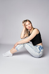 Portrait of a young woman on white background. Beautiful blonde woman wearing casual clothing, smiling and looking at camera