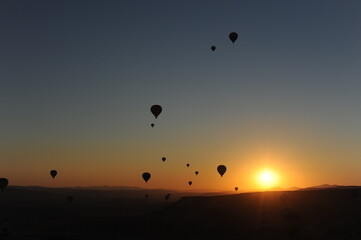 Beautiful view of hot air balloons floating in the air at sunrise with clear sky in Cappadocia, Turkey (Türkiye)