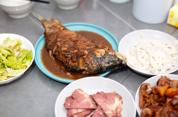 A plate of braised carp and other side dishes