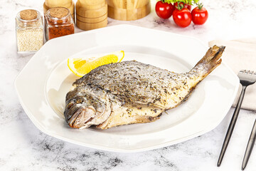 Baked Dorado fish served lemon