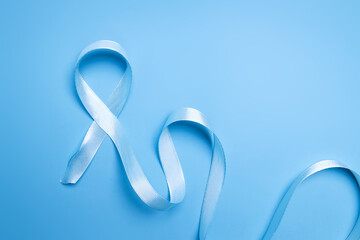 Blue ribbon on blue background for world diabetes day or prostate cancer awareness month
