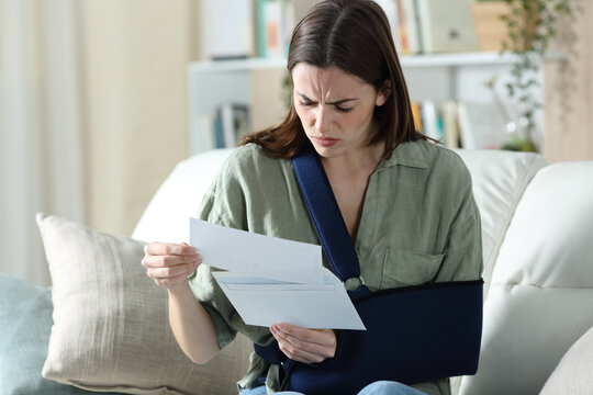 Convalescent worried woman reading document at home
