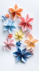 Obraz premium An arrangement of colorful origami flowers crafted from folded paper showcasing creativity and artistic expression against a simple background