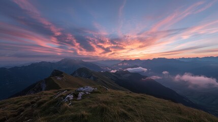 Sunset in the Alps mountains, with a vibrant cloud layer beneath and a sky full of breathtaking colors