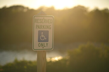 Reserved handicap parking sign on sunset